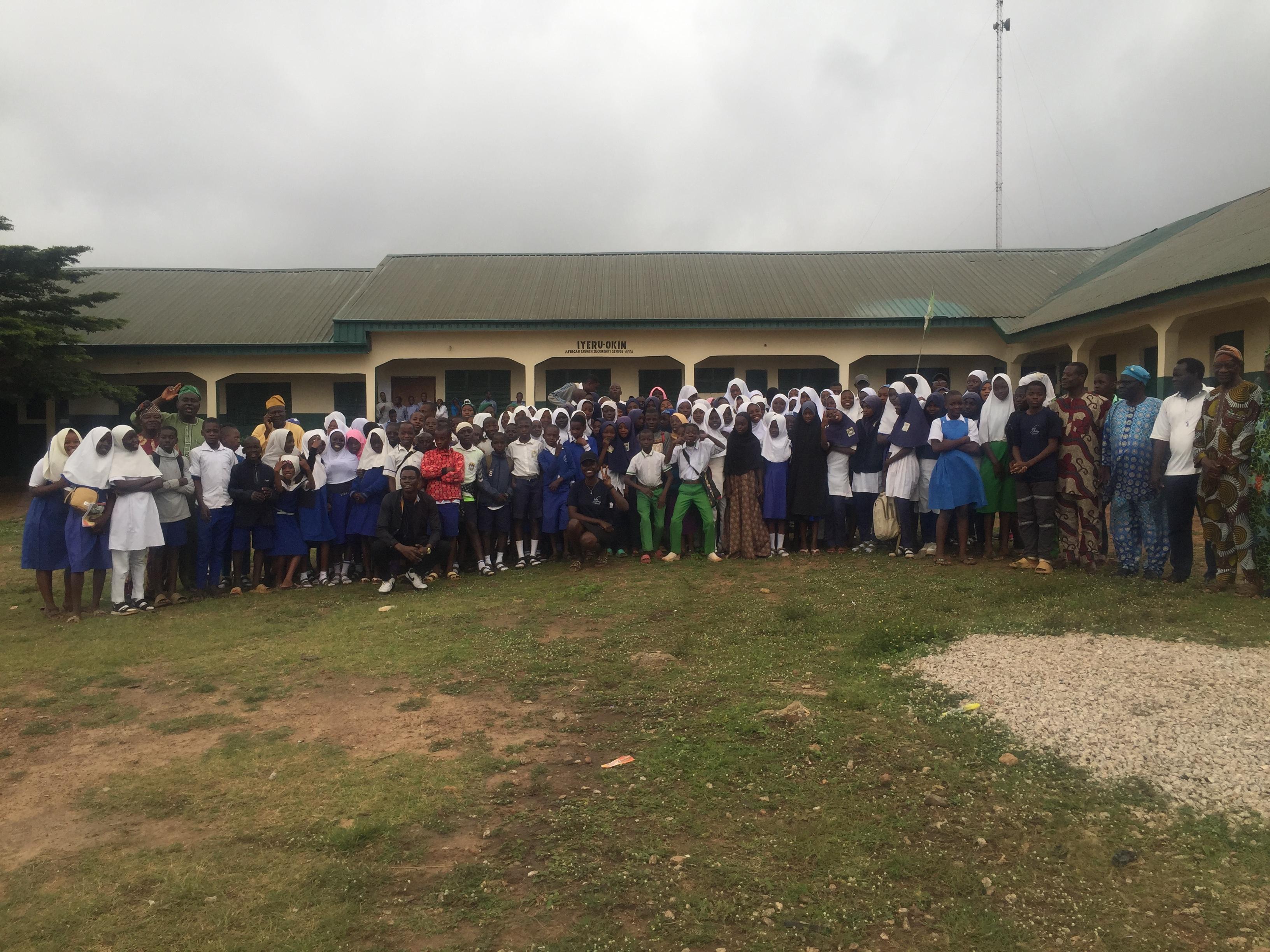 Students and educators gathered outside a community school