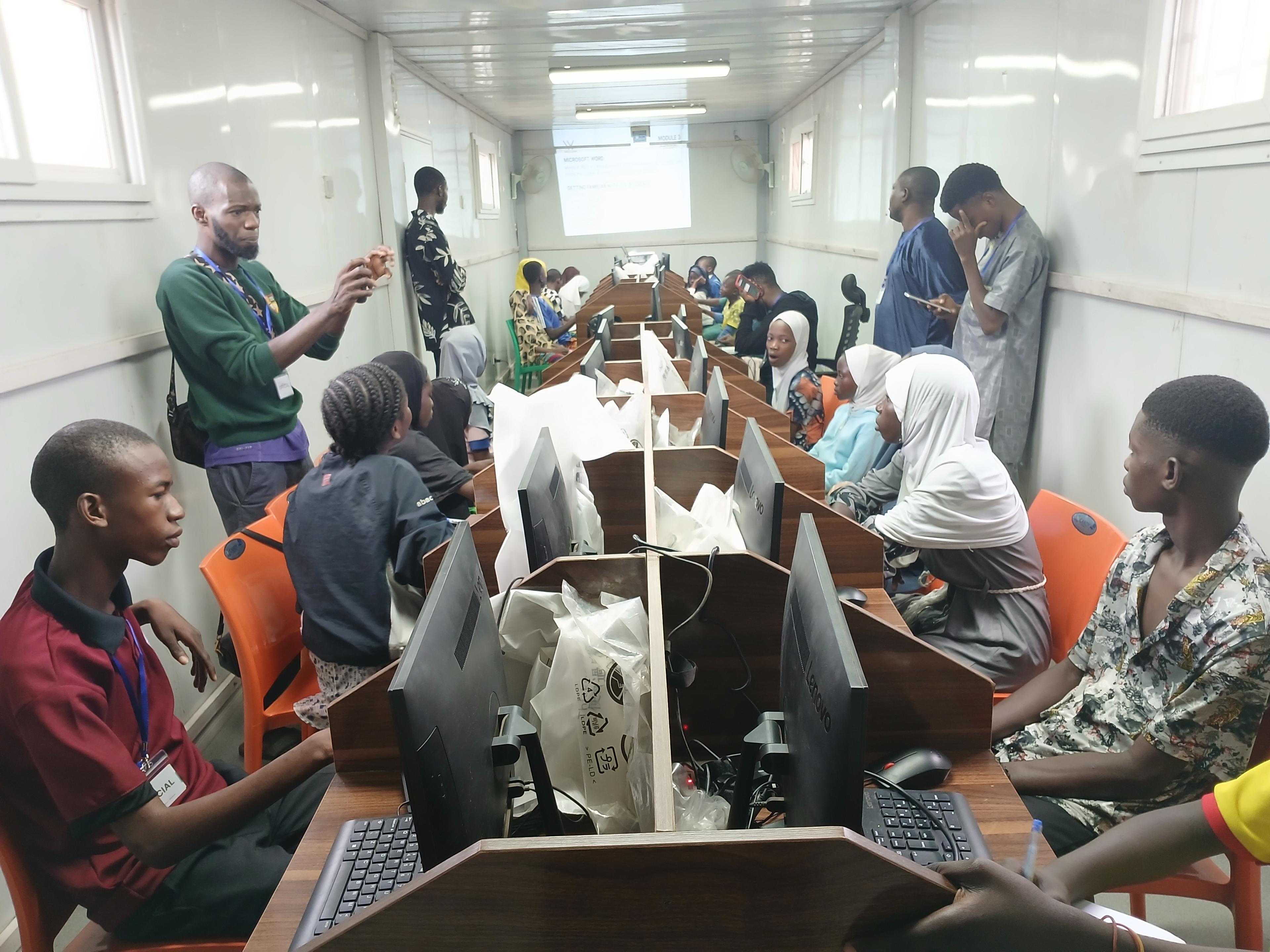 A volunteer instructor leading a computer-lab training session