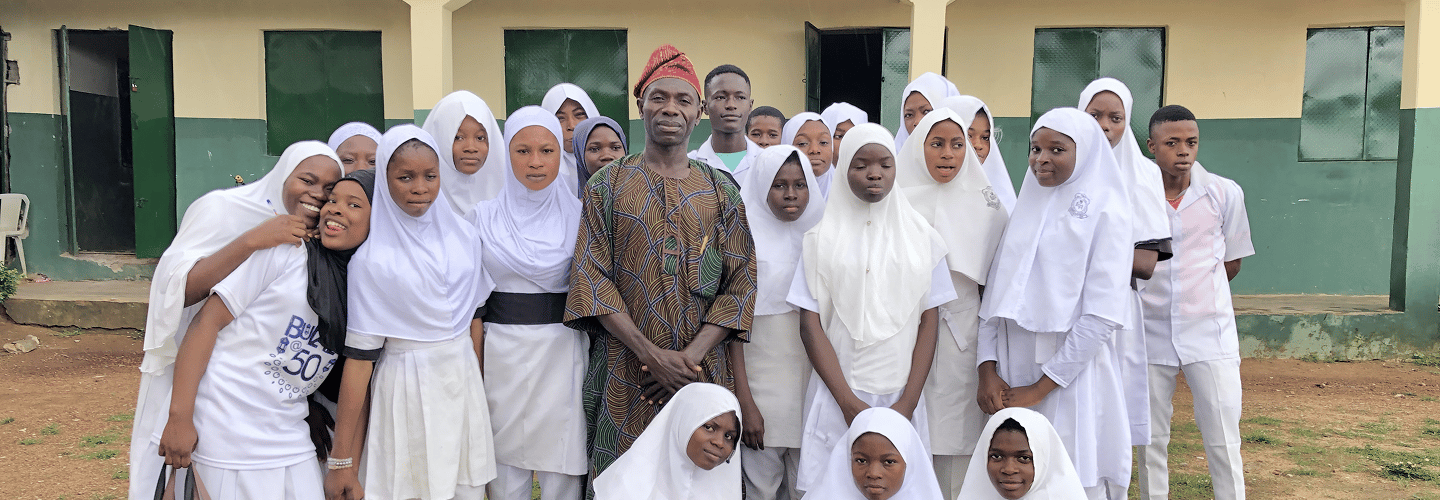 Whiz Academy learners and educators gathered outside a school